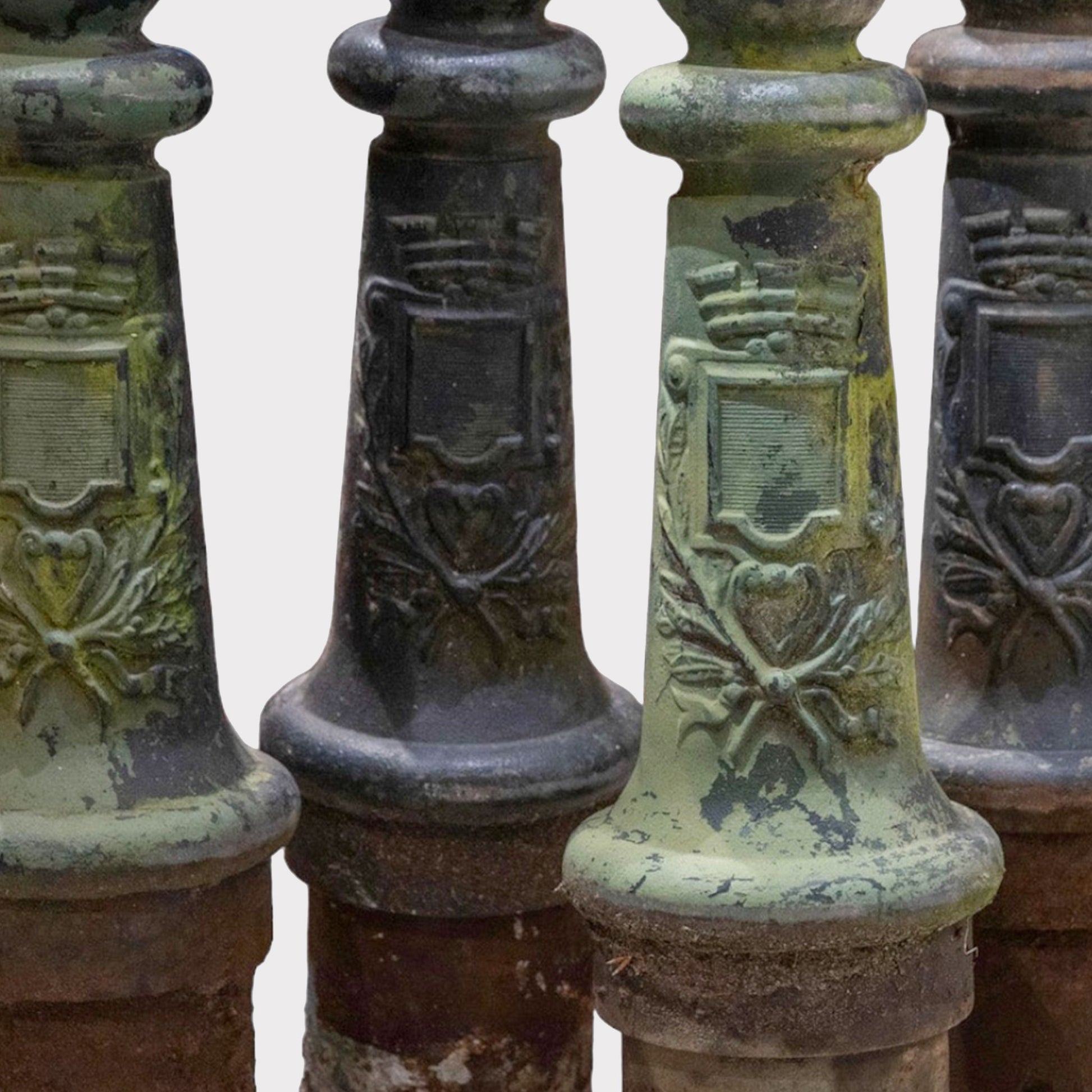 close up of a Image of a grouping of antique verdigris bollard posts