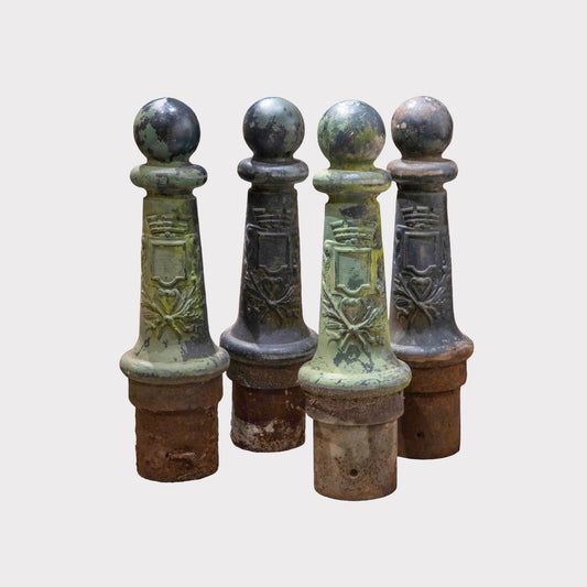 Image of a grouping of antique verdigris bollard posts